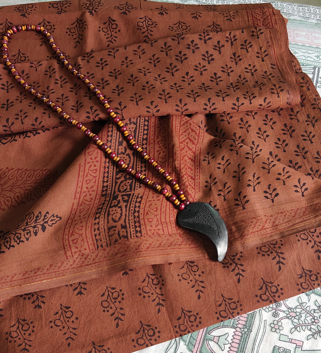 Artisan made wooden block prints on a Dola silk Saree, showcasing traditional Bagh floral motifs in red and black with Brownish red ascent