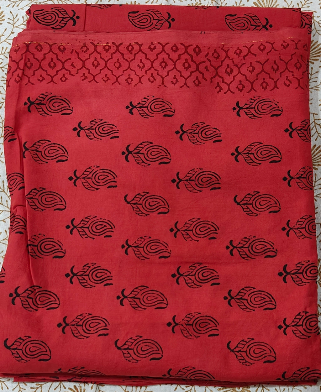 Traditional Dhar Bagh hand block print unstitched suit set in pure cotton, featuring intricate red and black handmade motifs with a matching dupatta
