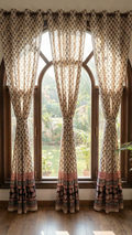 Set of handmade Bagh block print in traditional offwhite with black tree block and madder red pattern with big leaf bold border three curtains on a classy window.