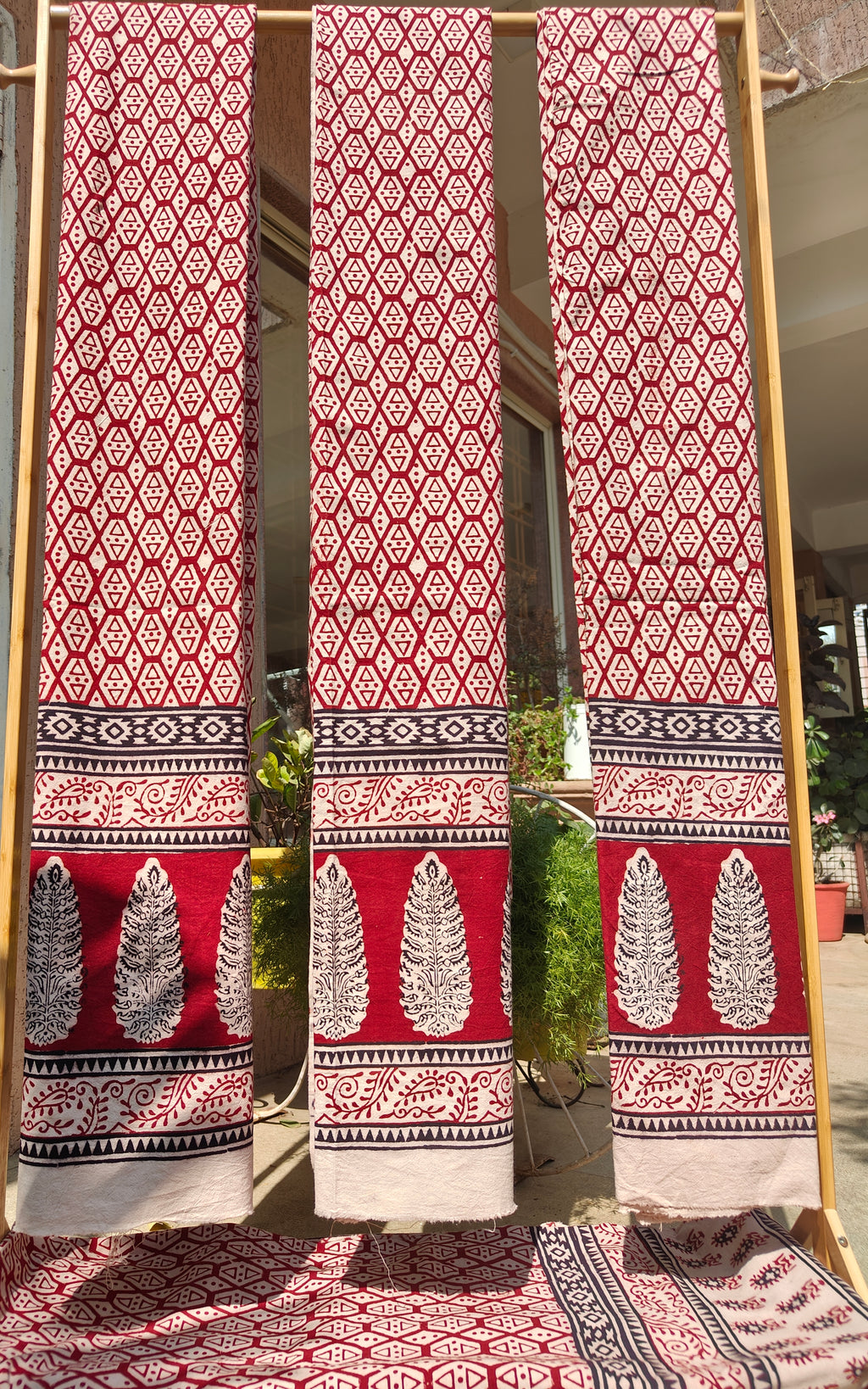 Set of handmade Bagh block print three curtains in traditional offwhite and madder red geometric patterns.