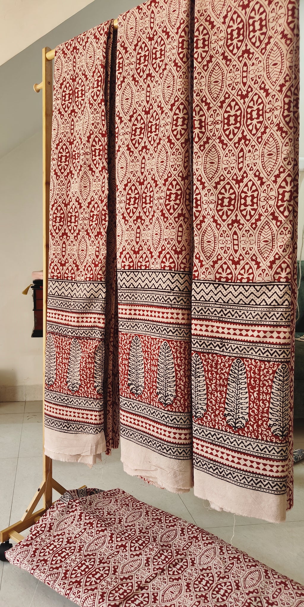 Pair of handmade Bagh block print curtains in traditional white and madder red geometric patterns, black and white traditional patterned borders.
