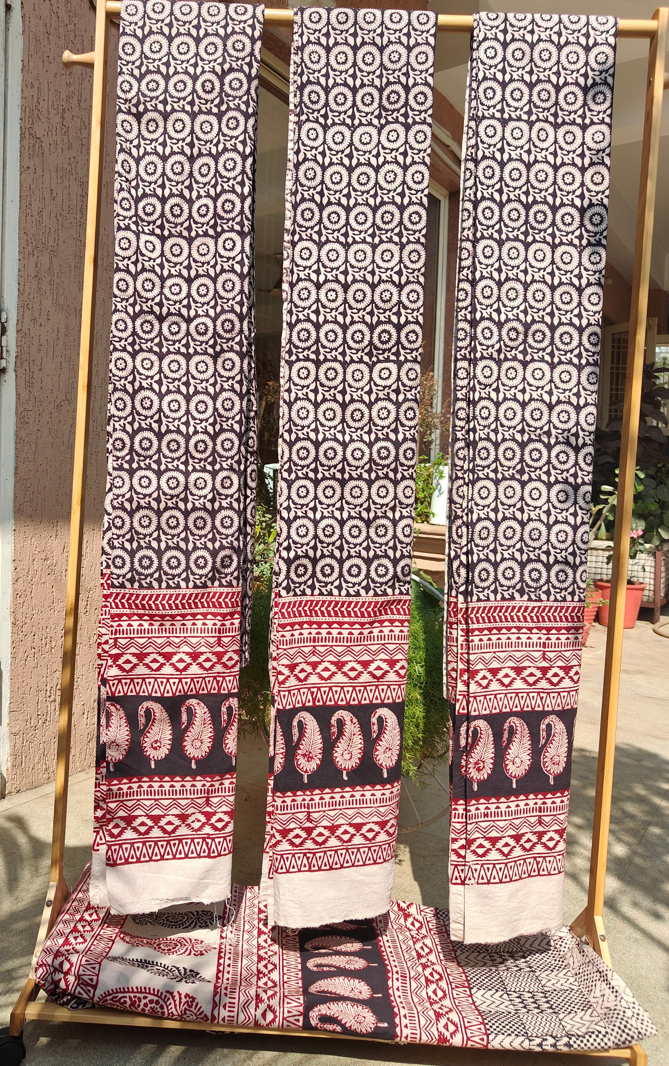 Handmade Bagh block print curtains in traditional black, white and madder red geometric patterns.