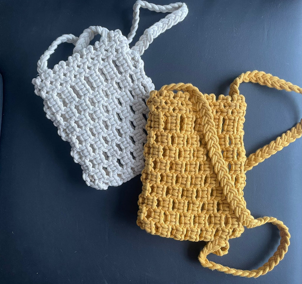 Minimalist macrame mobile sling bag with a long crossbody strap and a secure geometric knot pattern for smartphones