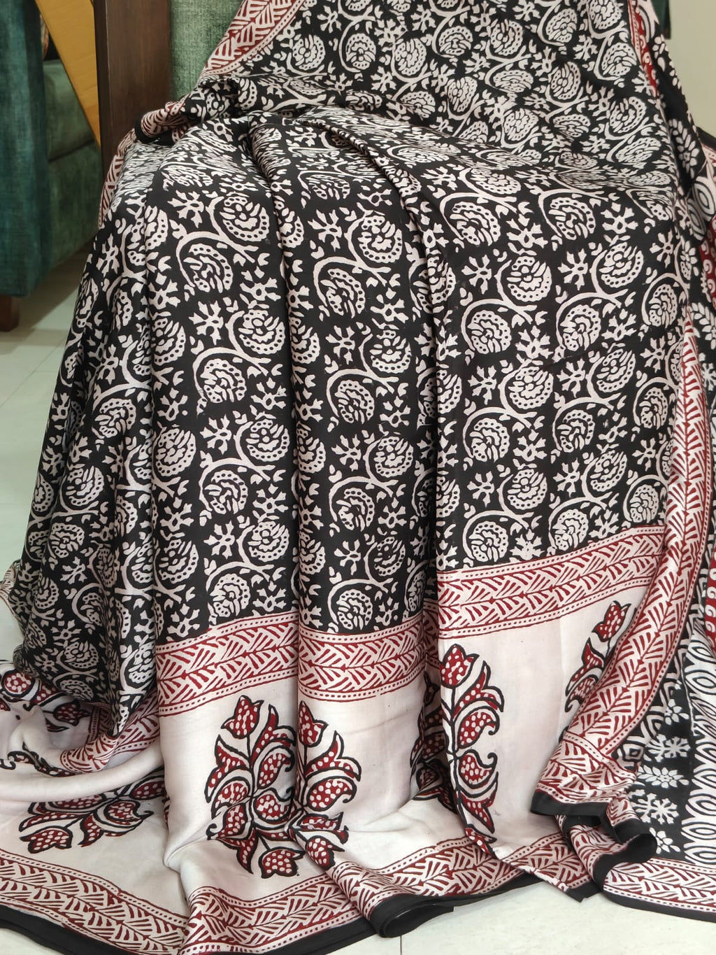 Artisan made wooden block prints on a Modal silk fabric, showcasing traditional Bagh floral motifs in Back and White with red ascent