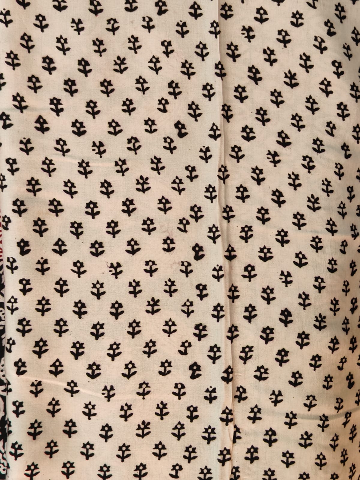 Artisan made wooden block prints on a Modal silk fabric, showcasing traditional Bagh floral motifs in Back and White with red ascent
