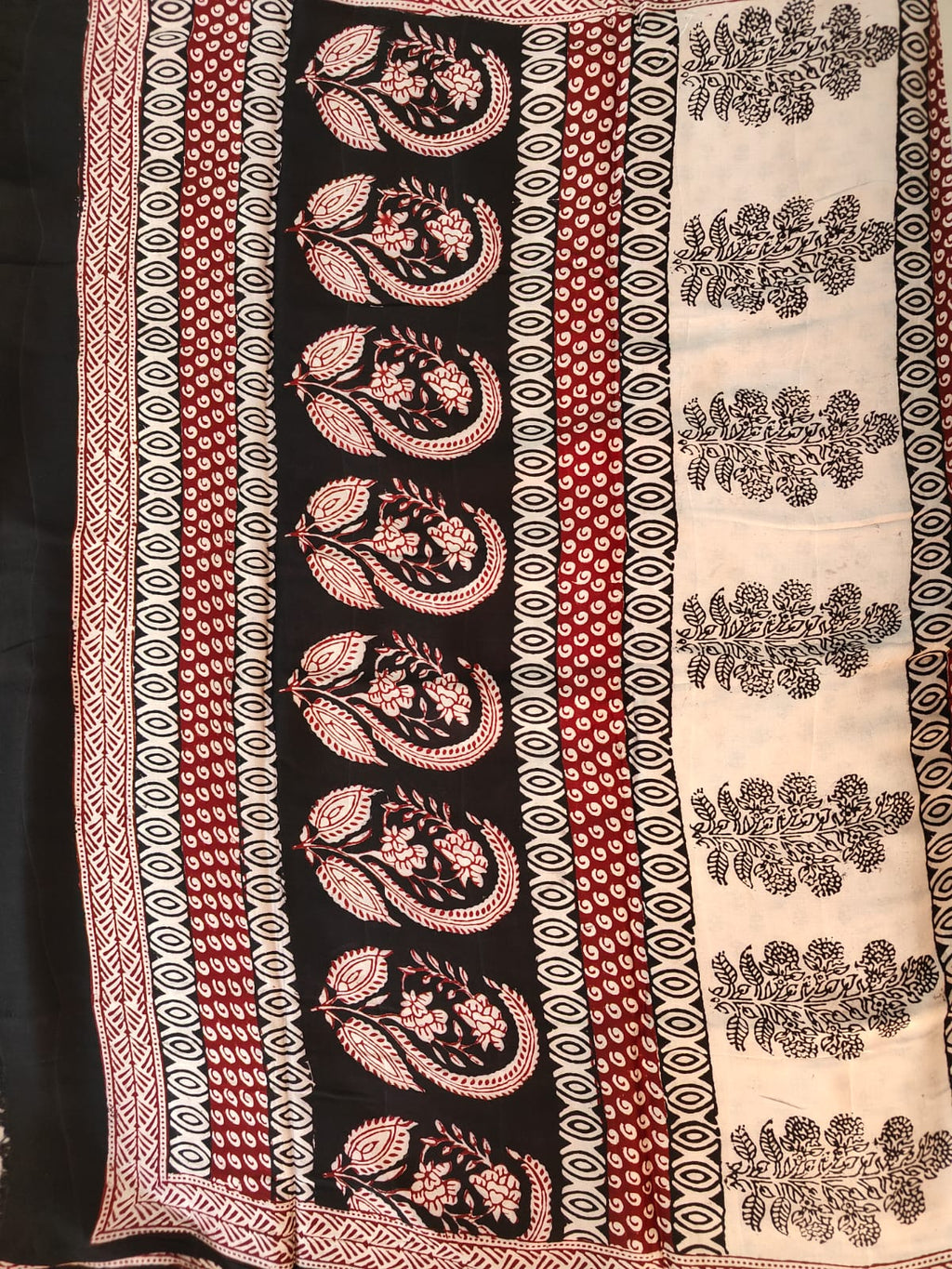 Artisan made wooden block prints on a Modal silk fabric, showcasing traditional Bagh floral motifs in Back and White with red ascent