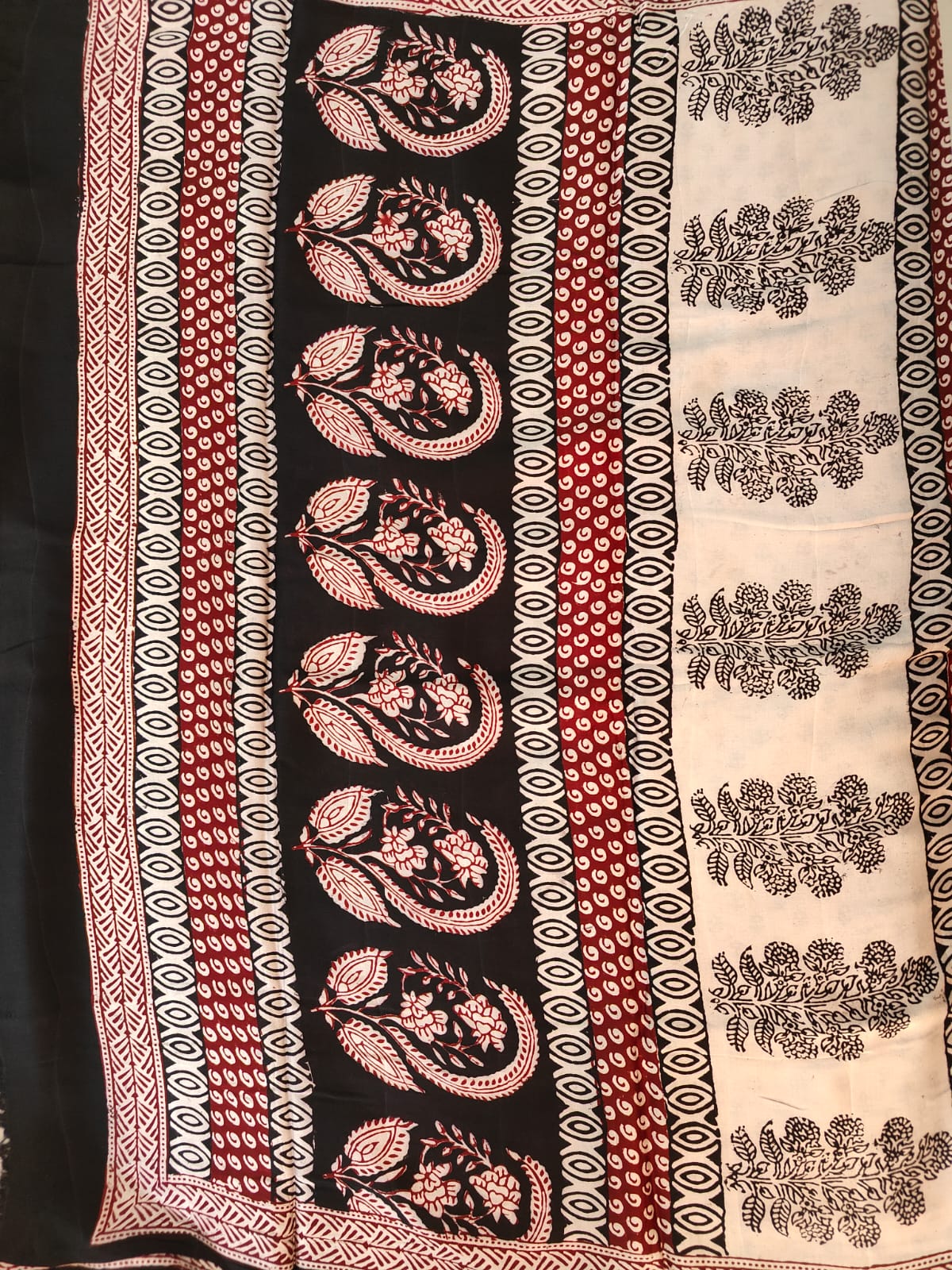 Artisan made wooden block prints on a Modal silk fabric, showcasing traditional Bagh floral motifs in Back and White with red ascent