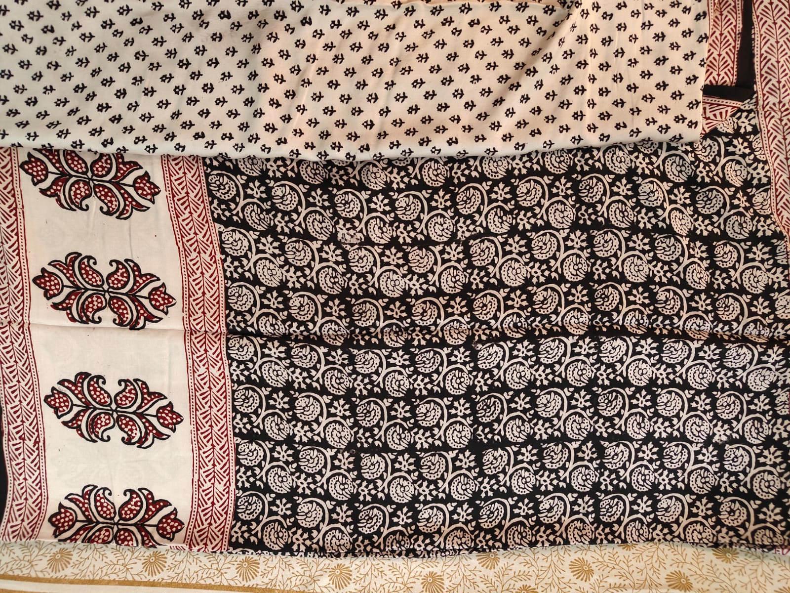Artisan made wooden block prints on a Modal silk fabric, showcasing traditional Bagh floral motifs in Back and White with red ascent