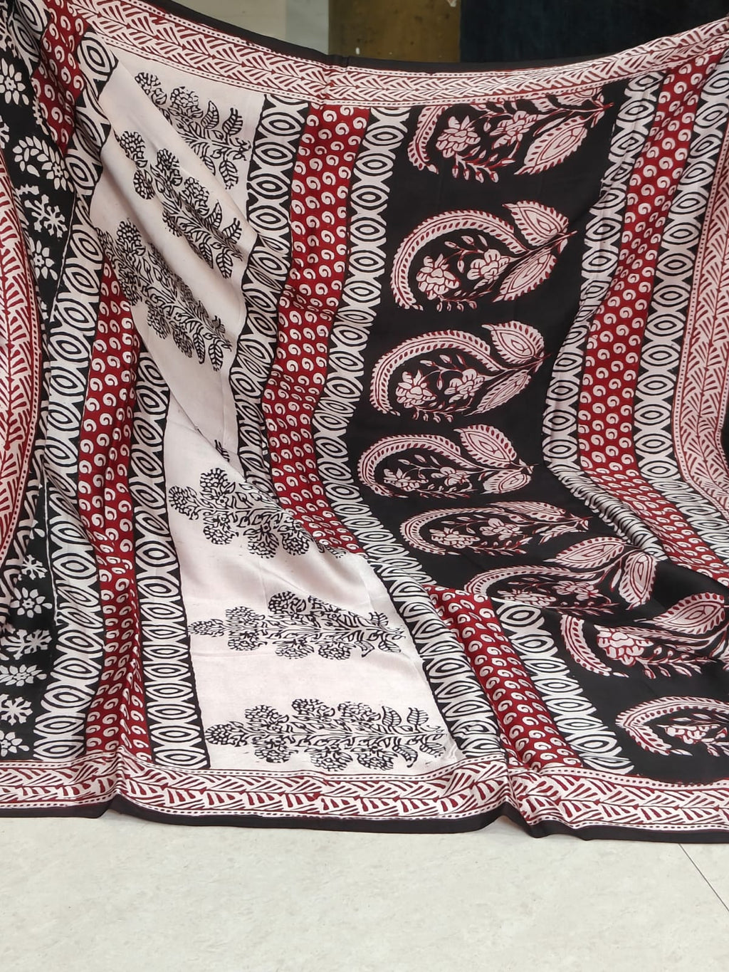 Artisan made wooden block prints on a Modal silk fabric, showcasing traditional Bagh floral motifs in Back and White with red ascent
