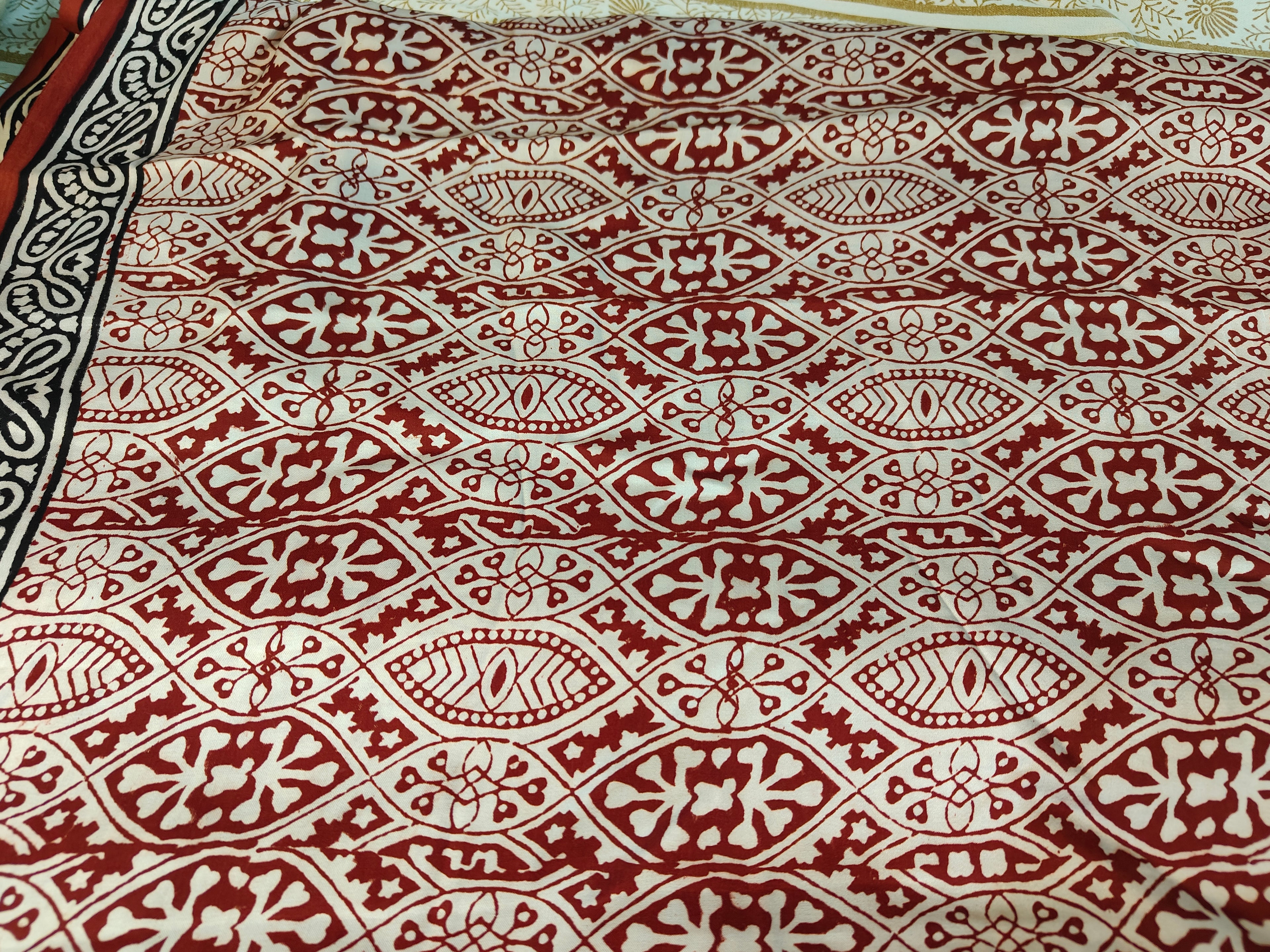 Sustainable luxury silk saree featuring authentic Dhar Bagh print; handmade blocks in rich white and maroon