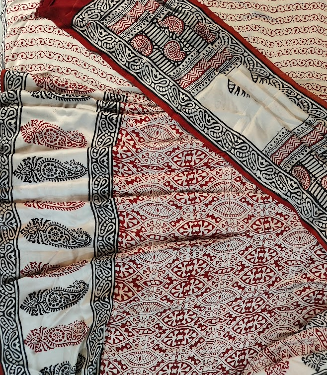 Sustainable luxury silk saree featuring authentic Dhar Bagh print; handmade blocks in rich white and maroon