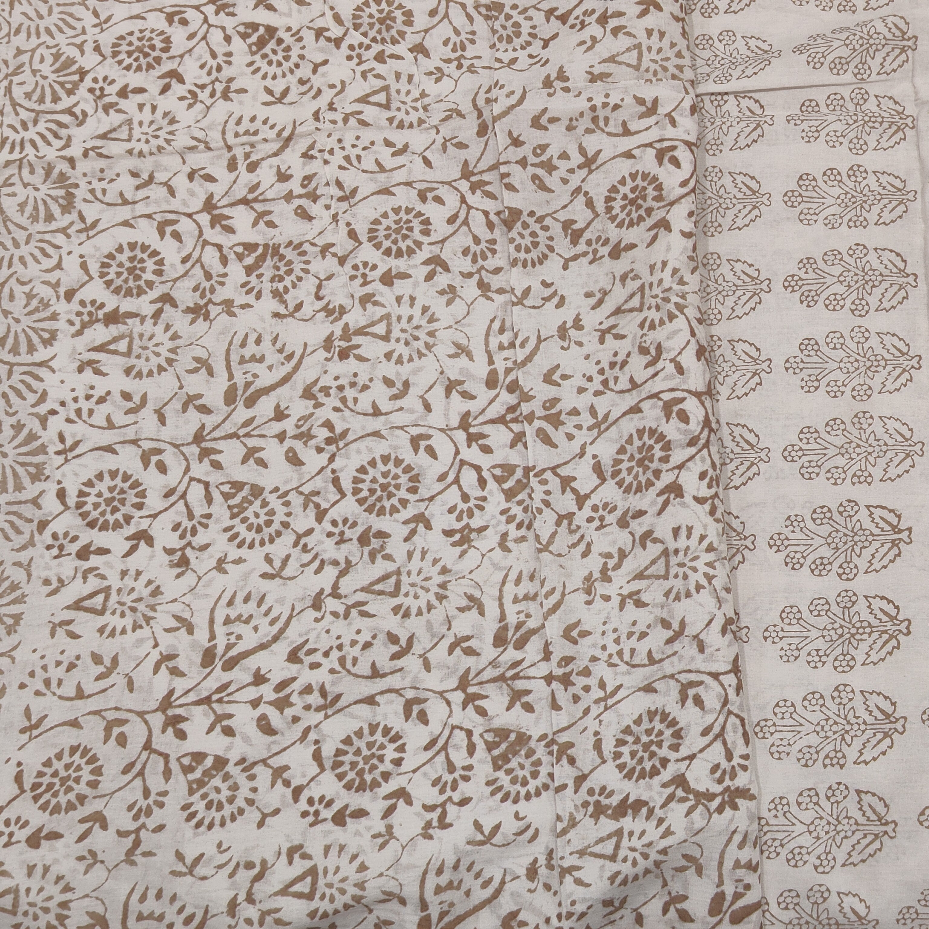 Traditional Dhar Bagh block print on off-white pure cotton fabric; copper-colored handmade big leaf motifs on an unstitched suit set with dupatta