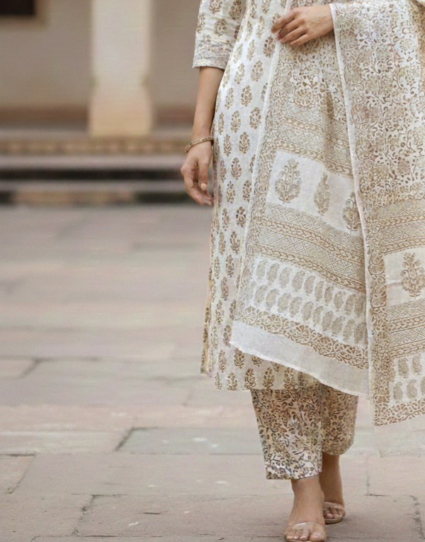 Traditional Dhar Bagh block print on off-white pure cotton fabric; copper-colored handmade big leaf motifs on an unstitched suit set with dupatta
