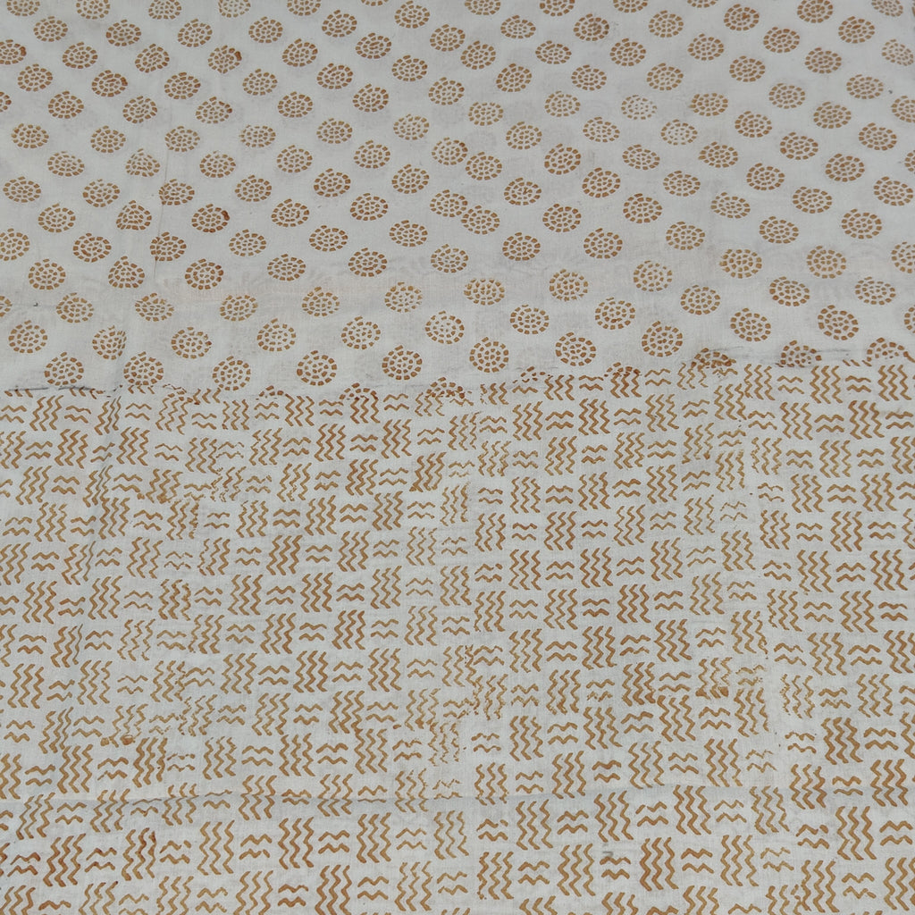 Traditional Dhar Bagh block print on off-white pure cotton fabric; copper-colored handmade circular  motifs on an unstitched suit set with dupatta