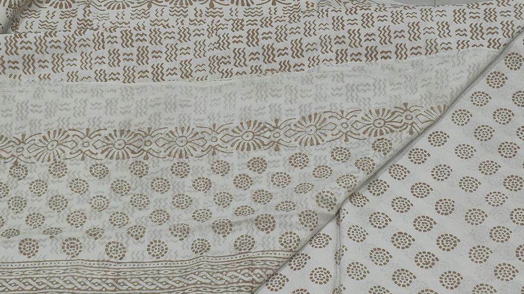 Traditional Dhar Bagh block print on off-white pure cotton fabric; copper-colored handmade big leaf motifs on an unstitched suit set with dupatta