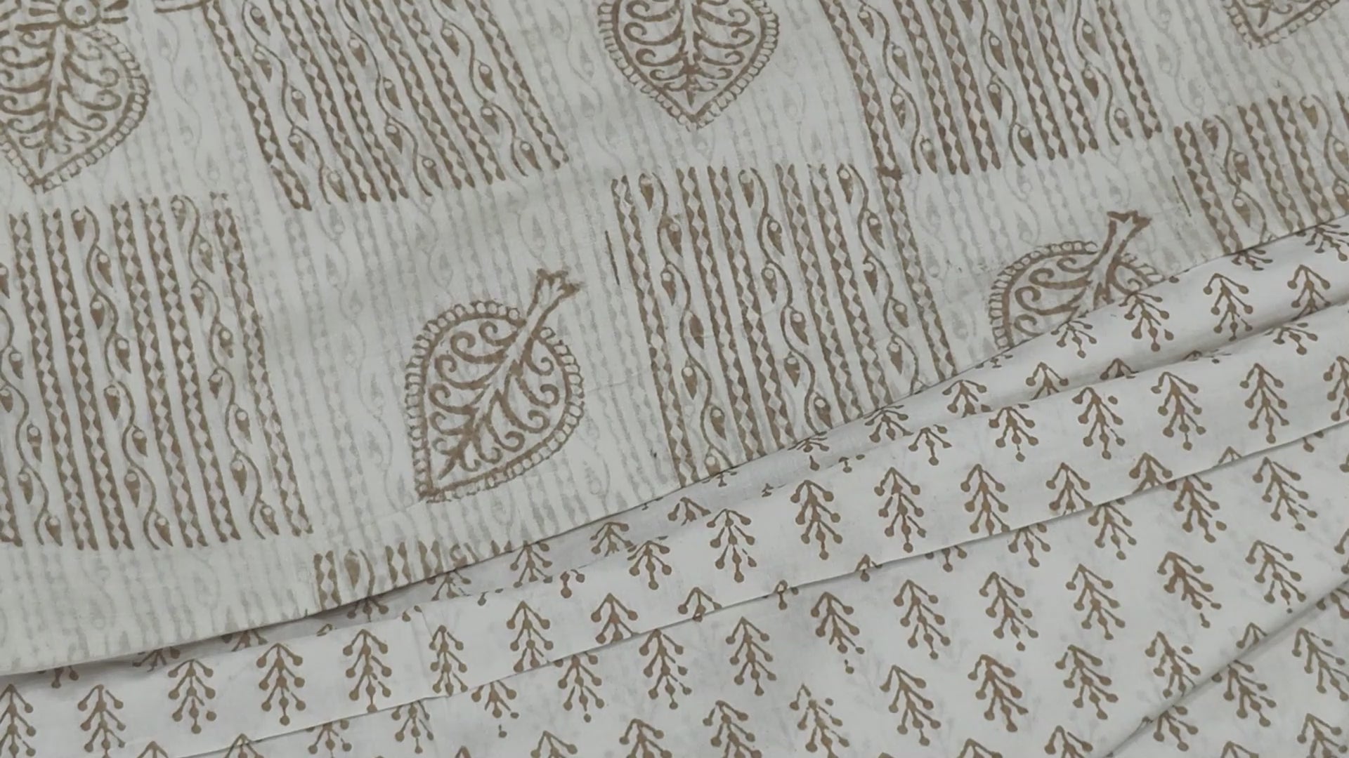 Traditional Dhar Bagh block print on off-white pure cotton fabric; copper-colored handmade palm leaf motifs on an unstitched suit set with dupatta
