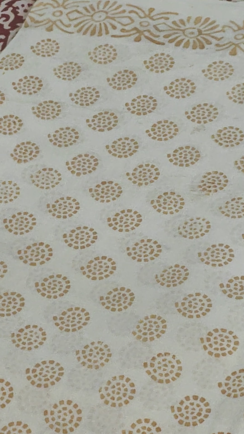 Traditional Dhar Bagh block print on off-white pure cotton fabric; copper-colored handmade circular  motifs on an unstitched suit set with dupatta