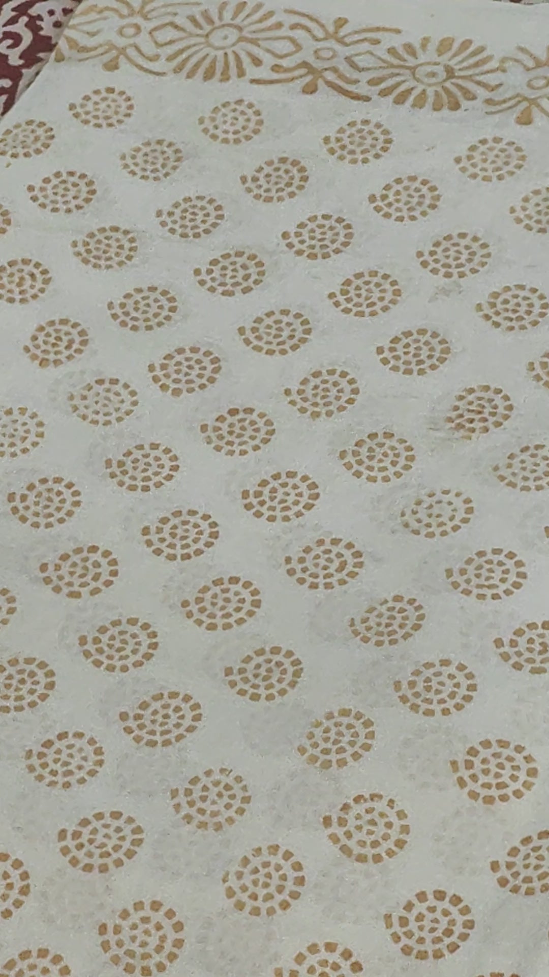 Traditional Dhar Bagh block print on off-white pure cotton fabric; copper-colored handmade circular  motifs on an unstitched suit set with dupatta