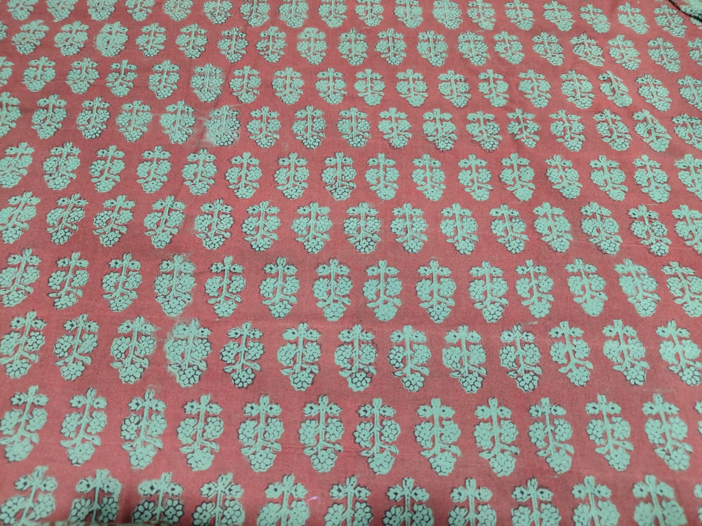 Bagh Block handmade cotton fabric for suite with green design on a red background