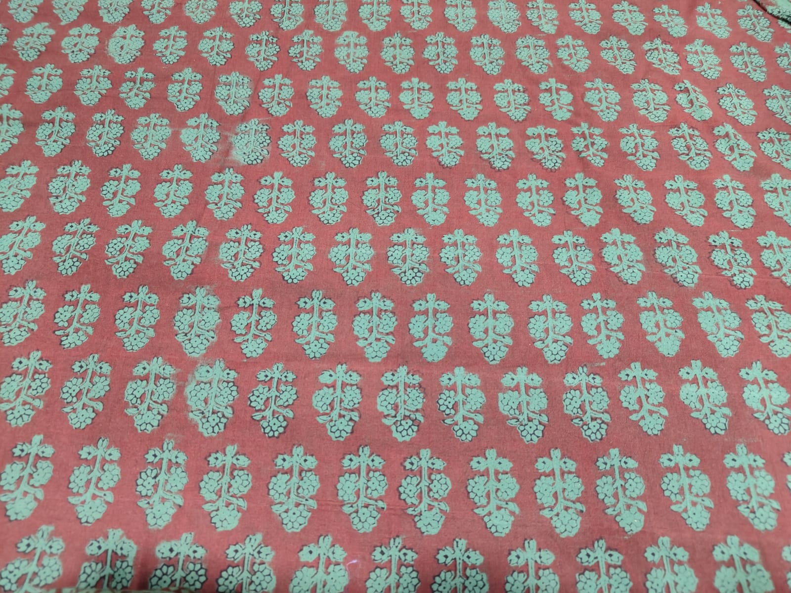 Bagh Block handmade cotton fabric for suite with green design on a red background