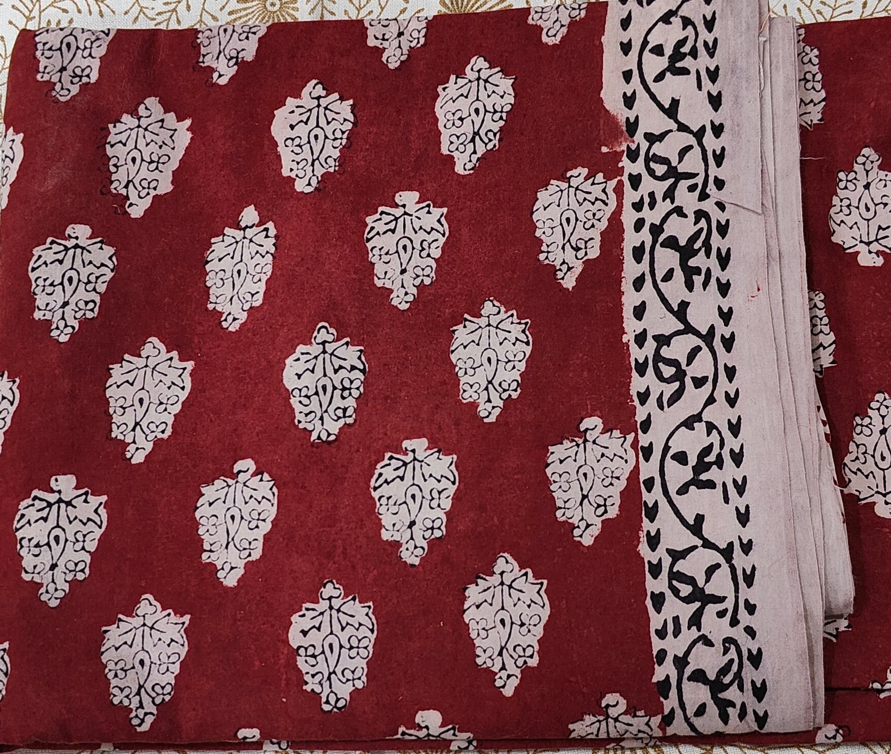 Traditional Dhar Bagh block print on  pure cotton fabric; maroon and white handmade motifs on an unstitched suit set with dupatta
