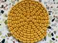 Set of circular macrame coasters , used as boho mug rugs on a wooden coffee table
