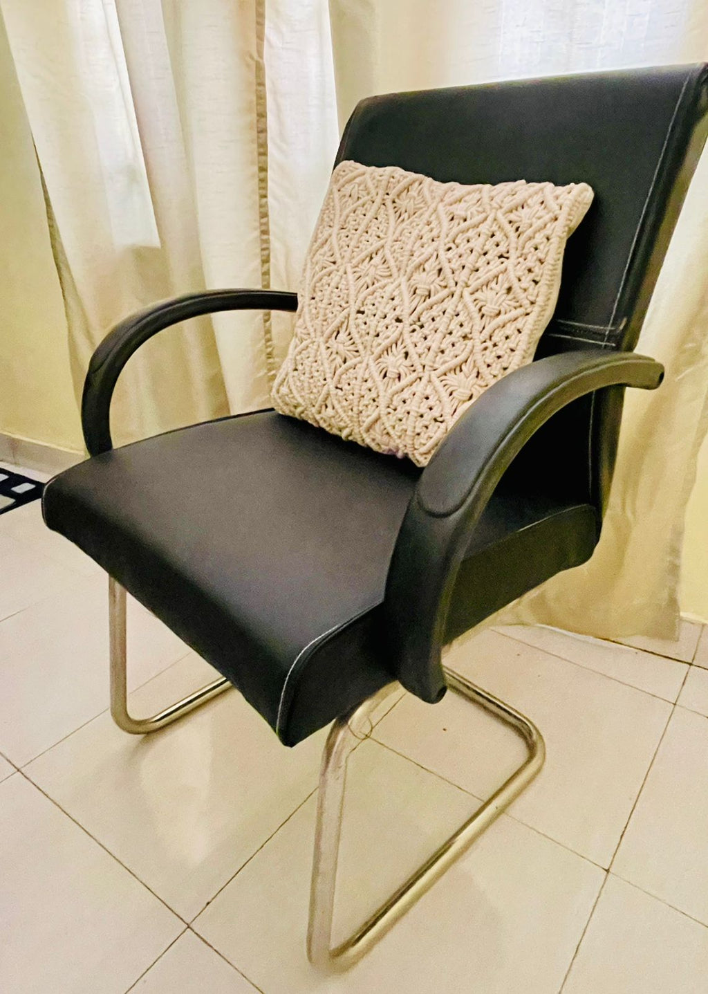 Square macrame cushion cover with intricate diamond knots, perfect for bohemian living room sofa styling